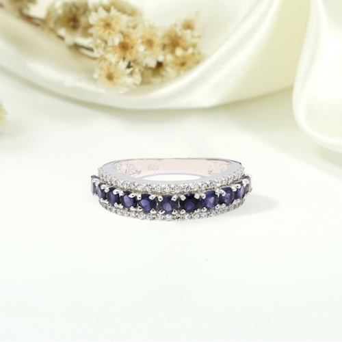 Silver ring with blue gemstones on a white background