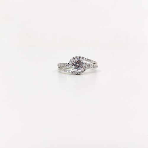 brilliant round-cut diamond simulant at the center, surrounded by a shimmering halo of CZ accents.